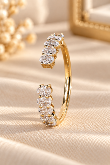 Oval lab-grown diamond open gap wedding band in yellow gold, angled front view