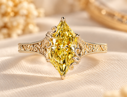 Yellow Dutch marquise ring with engraved shank, front view on cream fabric