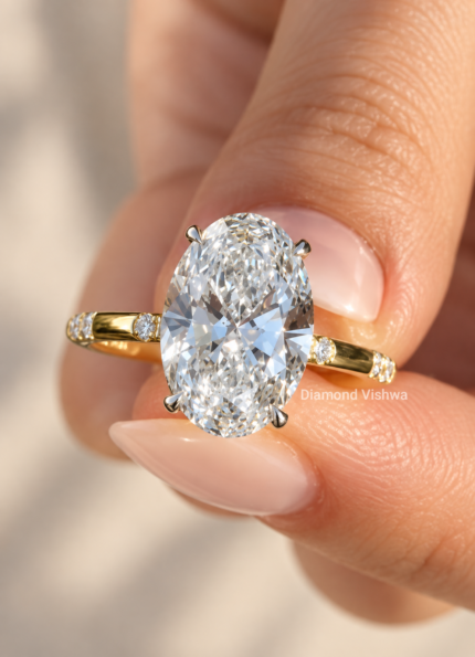 Front close-up of a 4 carat oval lab grown diamond engagement ring with pavé band in yellow gold