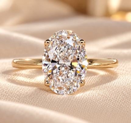 Oval floral basket ring with lab-grown center and hidden halo, front view on cream fabric