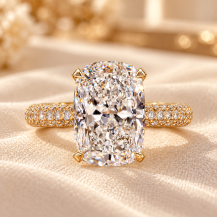 Elongated cushion pave ring with a lab grown center diamond and pavé band, front view on cream fabric