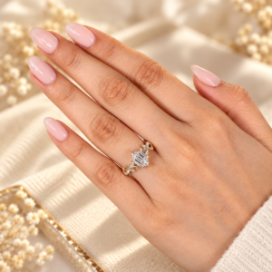 Hexagon step cut engagement ring beside neutral manicure