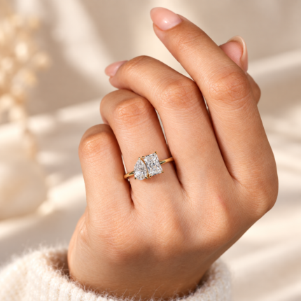 Toi et Moi diamond ring on a curled hand