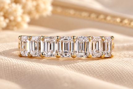 Front close-up of seven emerald cut lab grown diamonds in shared prongs