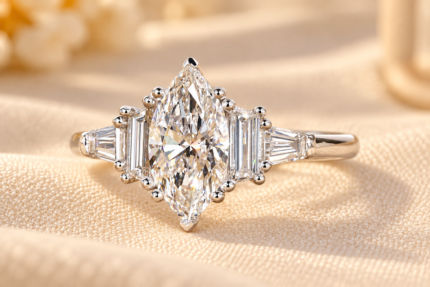 Marquise lab diamond cluster ring with baguette and trapezoid accents, front view on cream fabric