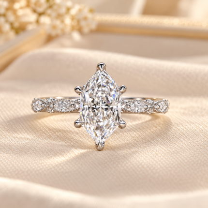 Front view of a marquise-shaped center and pavé shoulders in white-tone metal