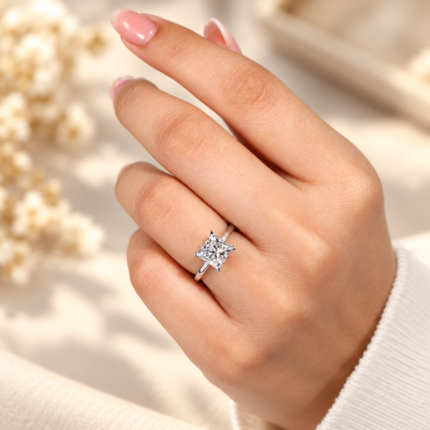 Princess cut moissanite cathedral solitaire ring, angled view on a hand