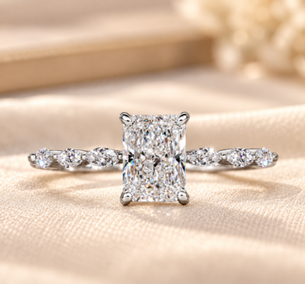 Radiant lab grown diamond ring with marquise accents, front view on cream fabric