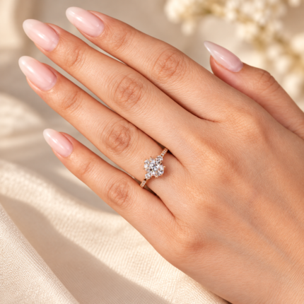 Oval three-stone ring worn on a hand